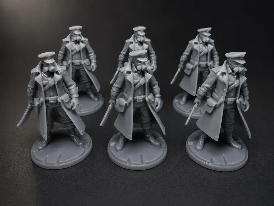 Custom manufactured grey figurines on a dark background